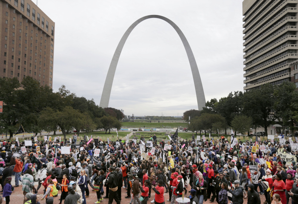 Protesters march past the St. Louis Arch on Saturday in St Louis. More than 1,000 gathered in downtown St. Louis for a second day of organized rallies to protest Michael Brown’s death and other fatal police shootings in the area and elsewhere.