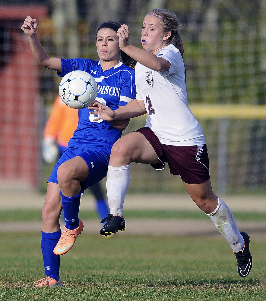 Monmouth Academy’s Haley Fletcher, right, races after the ball with Madison Area Memorial High School’s Monica Ouellette during a soccer match Monday in Monmouth. Madison won 2-1.
