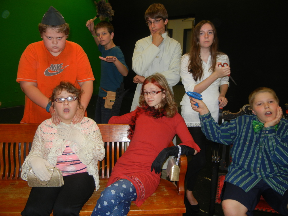 Maranacook Middle School players will present the comic who-done-it “Get a Clue” at 7 p.m. on Friday, Oct. 17, and 2 p.m. Saturday, Oct. 18, in the Maranacook Middle School cafe, Millard Harrison Drive in Readfield. Written and directed by Iona McCabe, the play is based on the classic board game “Clue” and is suitable for all ages. Tickets are available at the door and cost $7 or $5 for seniors and students.
Front, from left, in a scene from the play, are Andrea Harmon, Delaney Crocker, and Lucas Greifzu; back, from left, are Dillon McIntosh, Alec Kane, Graham Hannon, and Elise Clark. Other member of the cast include Lily Welch,  Noah Jones and Hannah Woodford.
