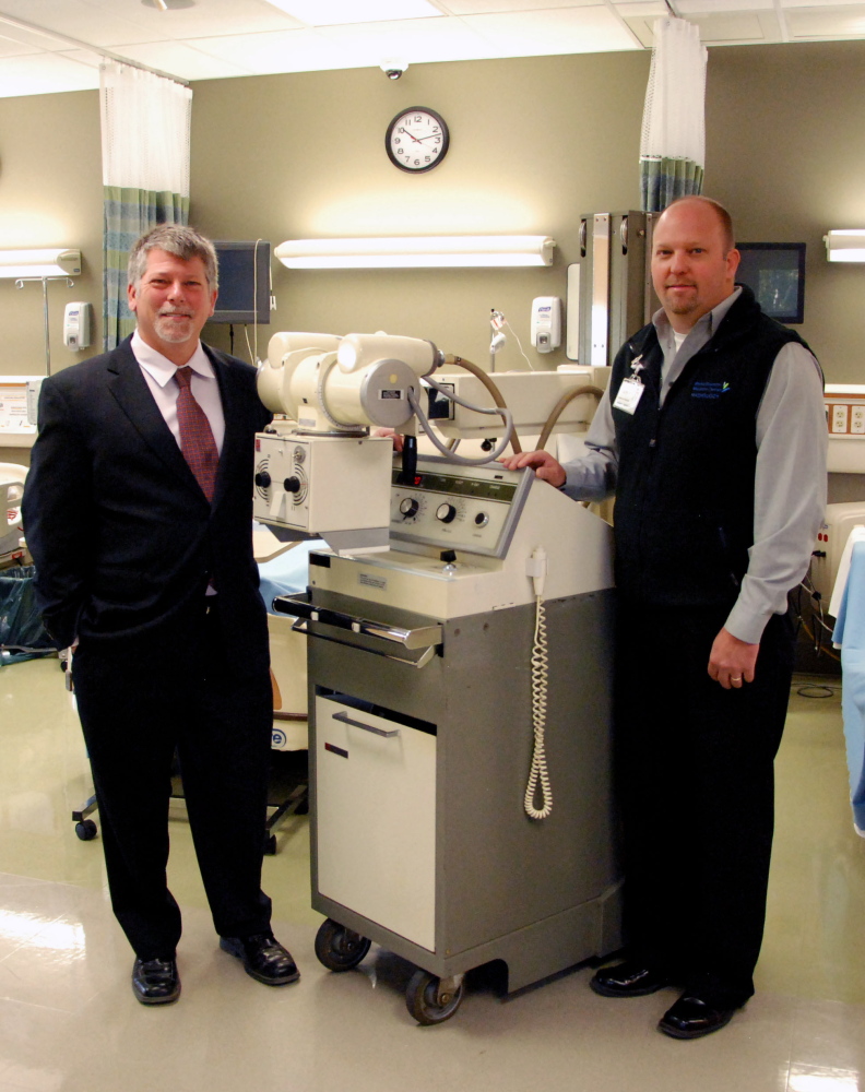 KVCC President Dr. Richard Hopper, left, and MaineGeneral Medical Center Imaging Manager Jeff Trask with the donated X-ray machine in KVCC’s TD Simulation Laboratory.