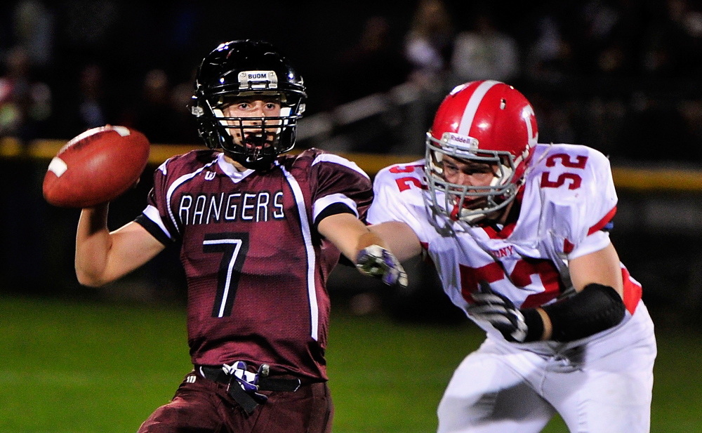 Staff file photo by Gordon Chibroski
In this October 2013 file photo Greely QB #7, Matt Pisini, prepares to pass to Connor Hanley in the end zone as Cony #52 Alex Neill tries to stop him. The two schools renew the rivalry Friday night.