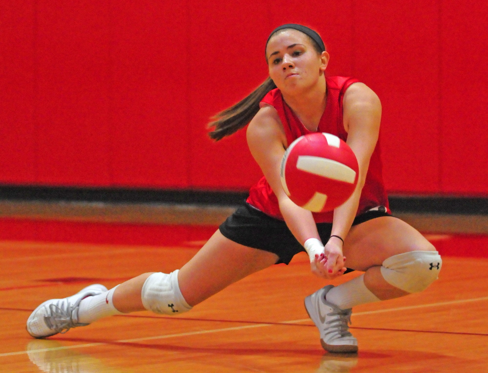 Cony’s Emily Russell digs the ball during a drill at practice Wednesday in the high school gym in Augusta.