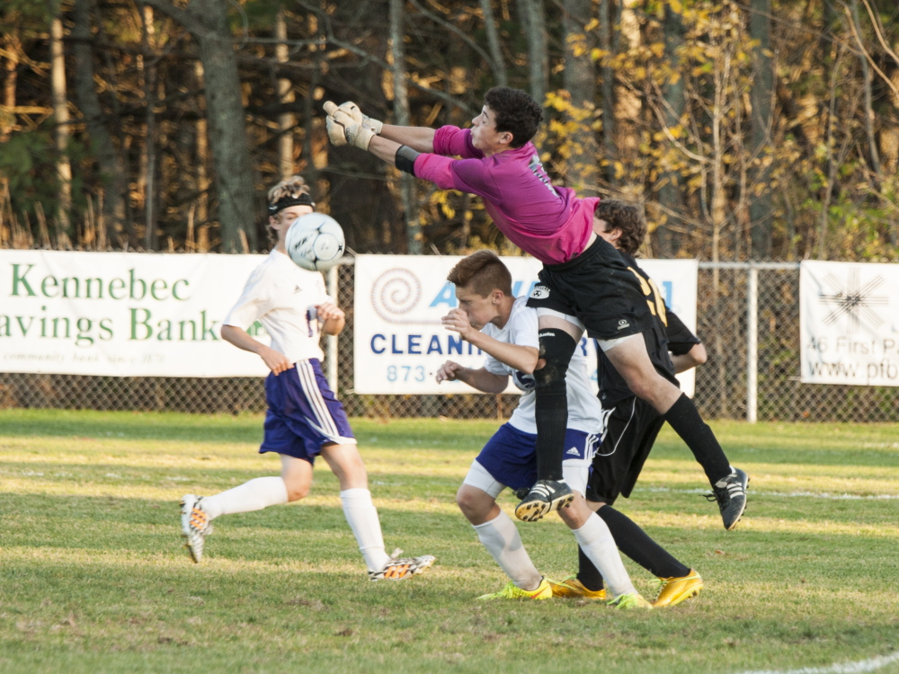 Waterville goalkeeper Liam Edwards jumps to make a save during the Purple Panthers’ game against Maranacook on Friday at Webber Field in Waterville. The Black Bears won 3-0.