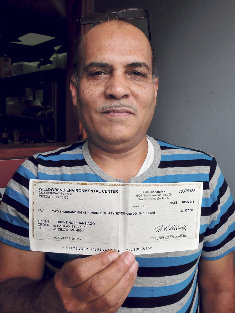 Florentino Santiago holds a bogus check he received on Wednesday. He wants people to know they should never deposit such a check and never pay money in order to collect winnings.