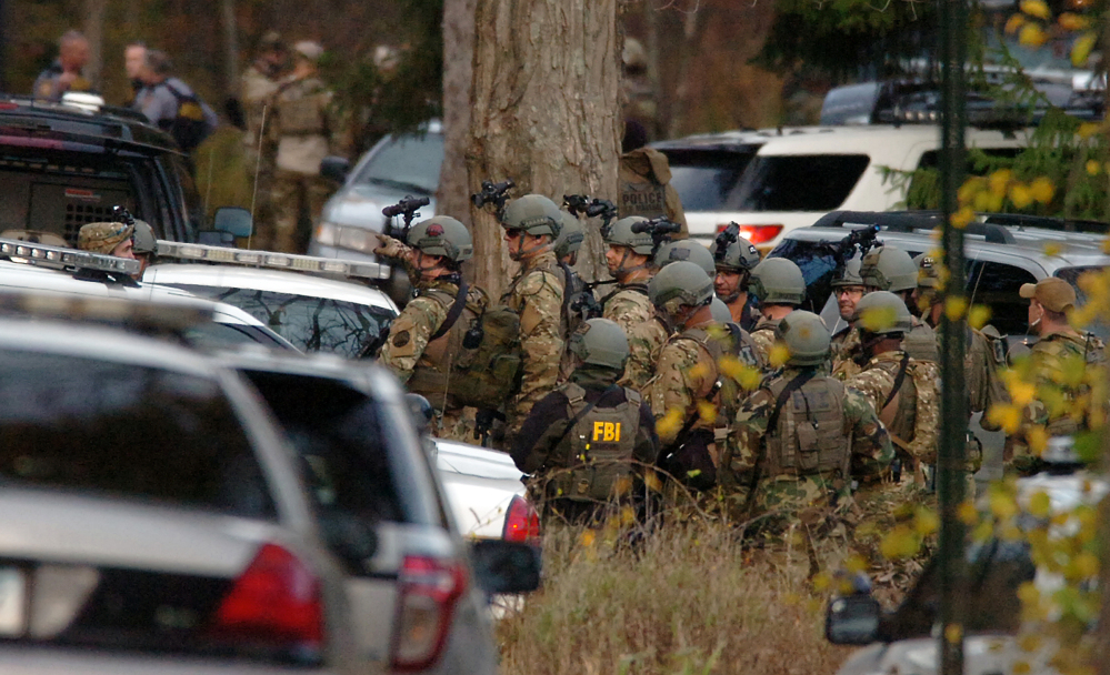 FBI agents prepare to patrol the woods on Lower Swiftwater Road on Saturday, during a massive manhunt for killer Eric Frein in Swiftwater, Pa.