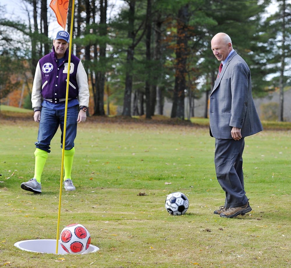 Comedian Bob Marley, left, watches as his par putt bounces out of the hole while Portland Mayor Michael Brennan lines up his put on the first hole as Riverside Golf Course introduces footgolf on its South Course.
