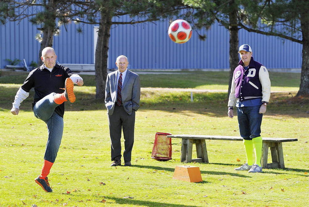 Local TV sports reporter Lee Goldberg “tees off” on the first tee as Portland Mayor Michael Brennan and comedian Bob Marley wait their turns as Riverside Golf Course introduces footgolf on its South Course on Monday.