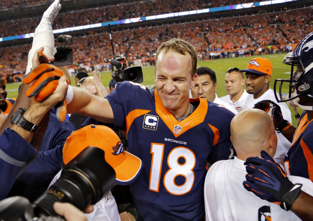 Denver Broncos quarterback Peyton Manning (18) celebrates his 509th career touchdown pass with teammates during the first half Sunday against the San Francisco 49ers in Denver.