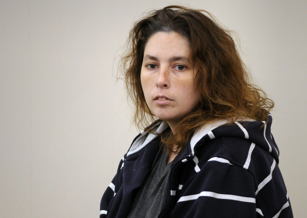 In this Friday, Sept. 12, 2014, file photo, Erika Murray enters the courtroom by a court officer for her arraignment at Uxbridge District Court in Uxbridge, Mass.