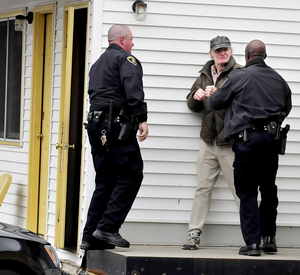 Skowhegan police officers Brian Crater, left, and Tim Williams arrest Robert Schanil after he crossed a cordoned-off area to enter his room Tuesday at the Towne Motel. The motel was evacuated earlier after an object resembling a hand grenade was found nearby.