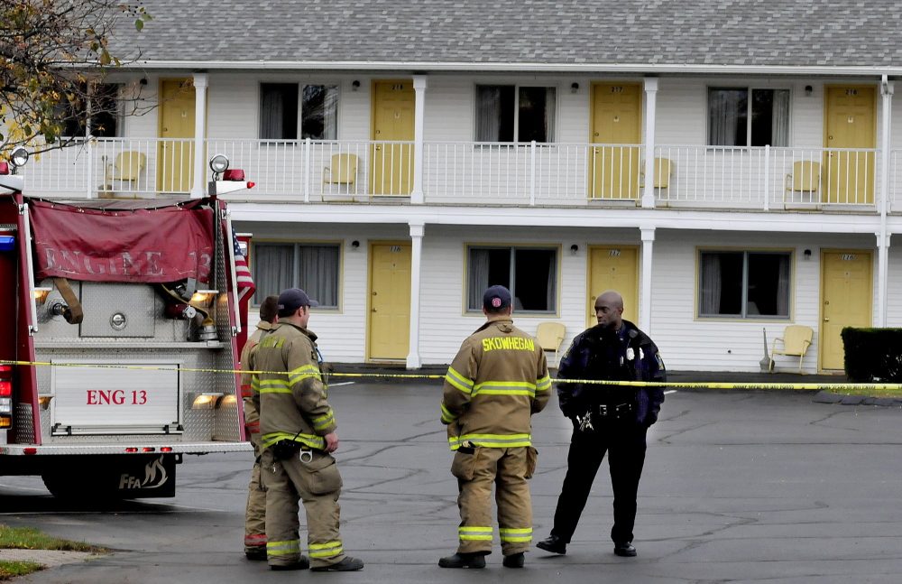 Skowhegan police and firefighters wait for a state police bomb team member to arrive Tuesday at the Towne Motel in Skowhegan after an employee discovered an object resembling a hand grenade. The object turned out to be a toy.