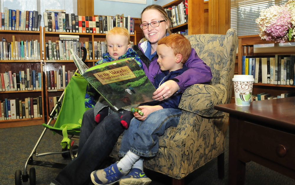 Kate Whitmore reads to her children Clark, left, and Rory on Tuesday at the Wilton Free Public Library. Whitmore said she thinks the library’s decision to start selling coffee is a great idea. “It should bring more people here and have them stay longer,” Whitmore said.