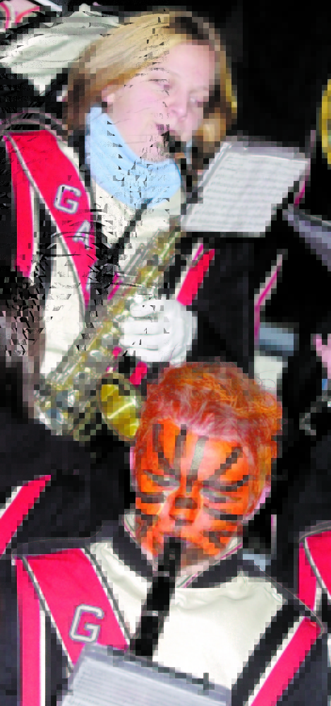 Staff file Photo by Joe Phelan 
 Gardiner Area High School band members Rose Smith, top, and Valarie Lohan play before the 2004 football rivalry game between Gardiner and Cony high schools at Alumni Field in Augusta.