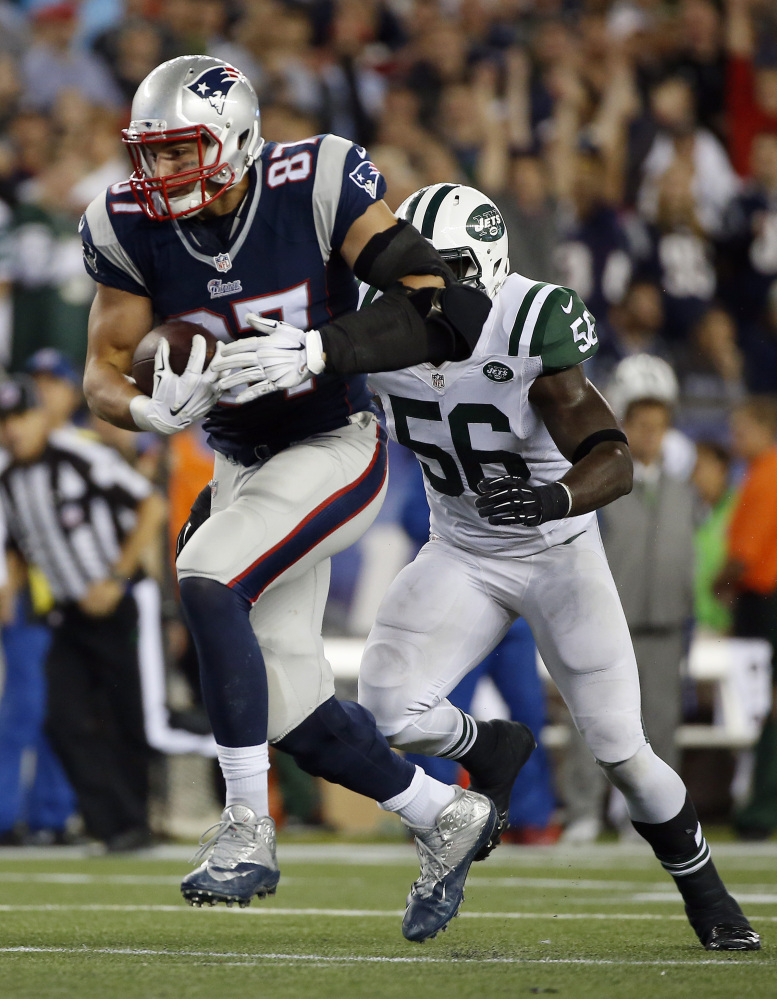 New England Patriots tight end Rob Gronkowski (87) runs from New York Jets inside linebacker Demario Davis (56) after catching a pass during the second half last week in Foxborough, Mass. The Patriots play the Chicago Bears on Sunday.