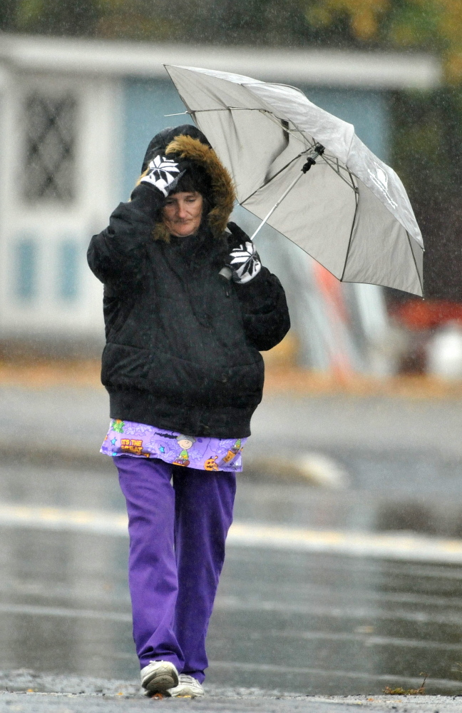 Priscilla Campbell walks home in the cold rain on College Avenue in Waterville on Wednesday.