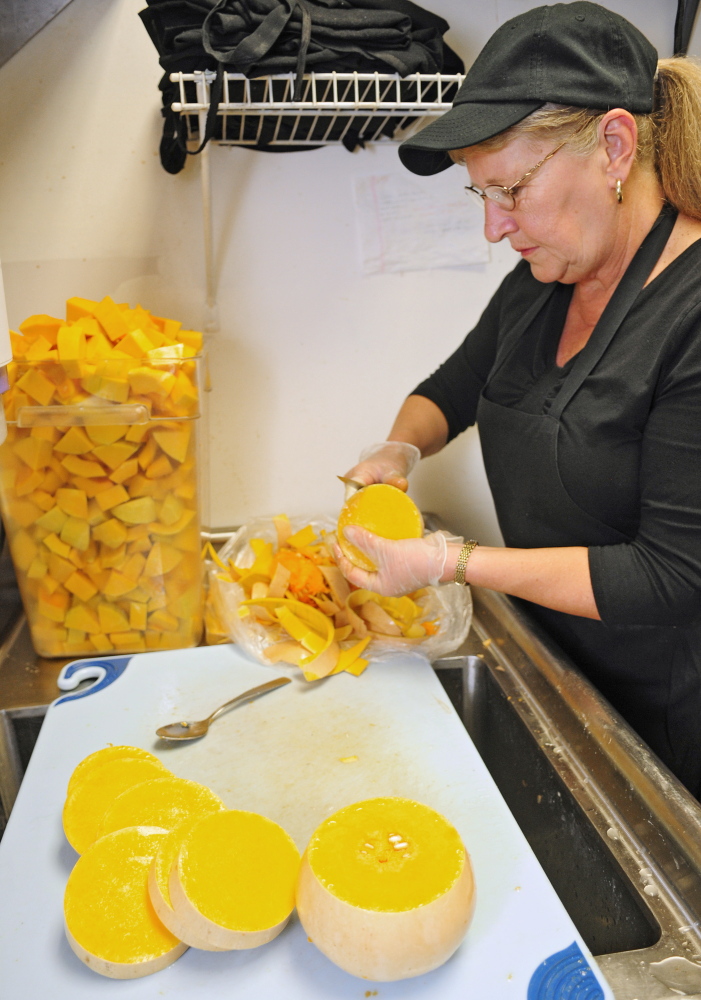 Joe Phelan/Staff Photographer
Cohen Center nutrition assistant Priscilla Pushard cuts up butternut squash that was grown by Kennebec County jail inmates.