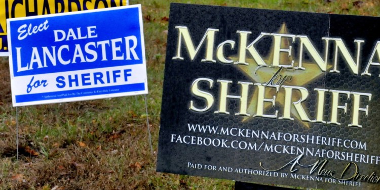 Political signs for both candidates for Somerset County Sheriff in Skowhegan on Thursday.