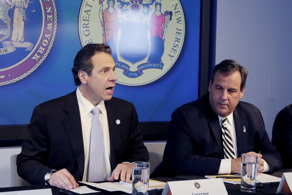 New York Gov. Andrew Cuomo, left, speaks as New Jersey Gov. Chris Christie listens at a news conference Friday in New York at which the governors announced a mandatory quarantine for people returning to the United States through airports in New York and New Jersey who are deemed “high risk.”