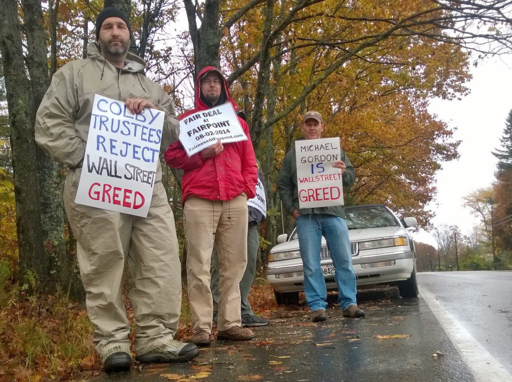Striking FairPoint employee Lee Pettengill is joined by two other picketers as electrical workers union members picketed a meeting of the Colby College trustees Friday in Waterville. A member of the Colby board, Michael Gordon, is chief investment officer for a hedge fund that the union said owns a large stake in FairPoint.