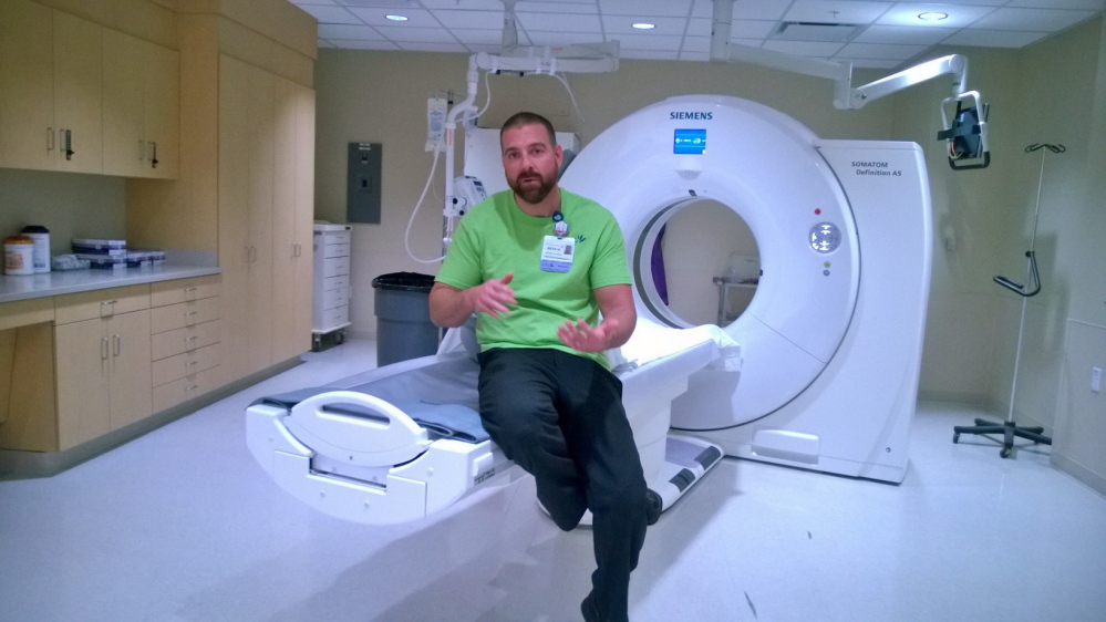 CAT scan coordinator Seth Hebert explains the new low-radiation CAT-scan machine at the Thayer Center for Health in Waterville. Compared to standard CAT-scan machines, the new device delivers 20 percent to 40 percent less radiation, depending on the size of the patient, he said.
