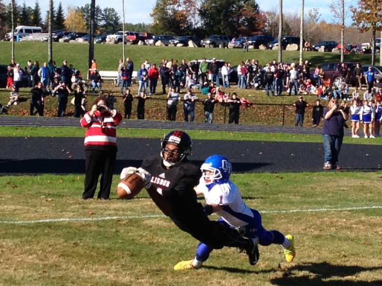 Oak Hill’s Adam Merrill, right, defends on a touchdown pass to Lisbon’s Henry Adams during Saturday afternoon’s Western D Campbell Conference showdown at Thompson Field. The Raiders won 28-14.