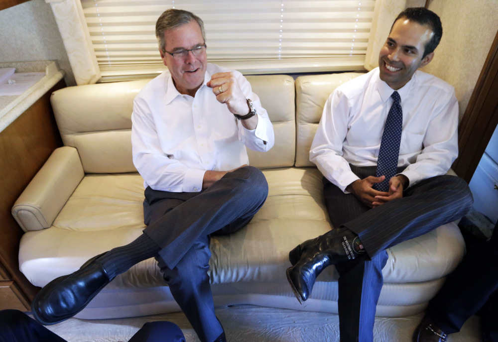 The Associated Press
This Oct. 14, 2014, file photo shows George P. Bush reacting as his dad, former Florida Gov. Jeb Bush, left, gives a fist pump during an interview in Abilene, Texas.