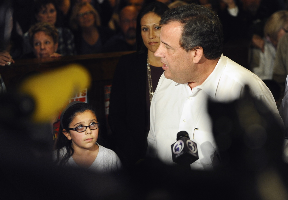 New Jersey Gov. Chris Christie answers questions from the media about nurse Kaci Hickox's quarantine at a rally for Republican candidate for Connecticut governor Tom Foley, Monday, Oct. 27, 2014, in Groton, Conn. (AP Photo/Jessica Hill)