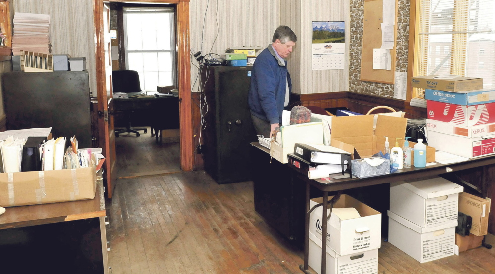 Robert Worthley, former administrative assistant for the town of Anson, prepares to remove office materials from the original Town Office building during its closuse in July 2014. The building was a victim of mold and sewer problems and a rodent infestation. While named one of the state’s endangered historic buildings, the Anson Town Office will be used for voting on Election Day next Tuesday and then will be closed for the winter, facing an uncertain future.