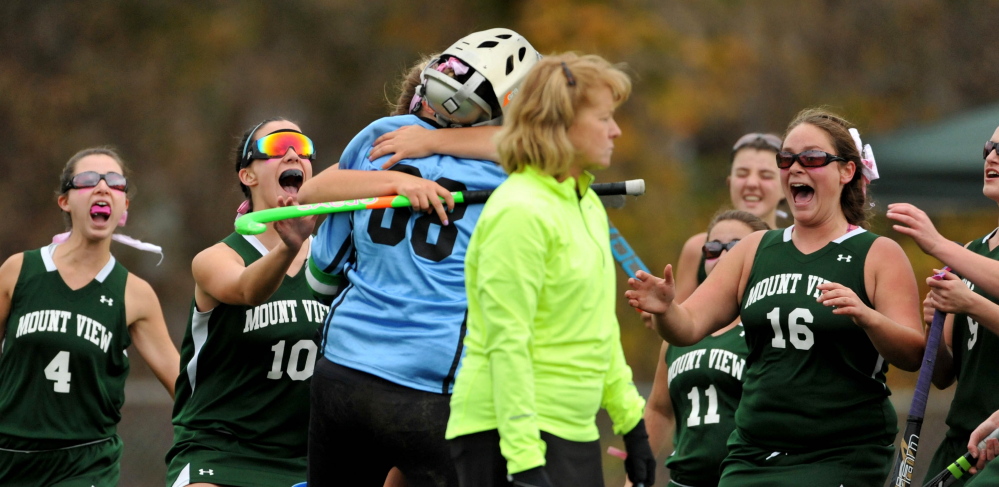 Mount View goalie Dinah Bilodeau, center, celebrates a penalty shot save with teammates in the second half of an Eastern C semifinal game Tuesday.