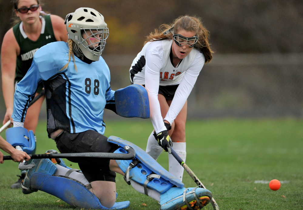 Mount View High School goalie Dinah Bilodeau (88)  makes a save as Winslow’s Maddie Roy, left, looks for the rebound in the second half of an Eastern C semifinal game Tuesday.