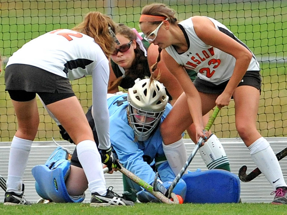 Mount View High School goalie Dinah Bilodeau, center, fights for the ball with Winslow’s Maddie Roy,  left, and Sarah Wildes in the second half of an Eastern C semifinal game Tuesday in Winslow.