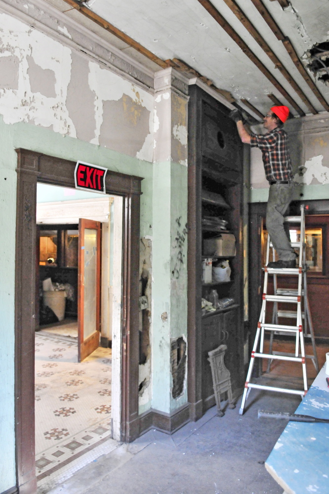 Chris Selwood works in the office of the old Colonial Theater on Oct. 8 in Augusta. He’s a volunteer with a group that is trying to renovate the theater, which opened in 1913 at 137 Water St. The theater is open 10 a.m. to 2 p.m. Saturday for an open house and tours for the last time this year.