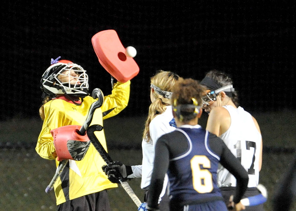 Skowhegan goalie Leah Kruse, left, makes a save during an Eastern A semifinal game Tuesday night against Mt. Blue at Thomas College in Waterville. Skowhegan prevailed 4-0 and will next play Lawrence in the regional final Thursday.