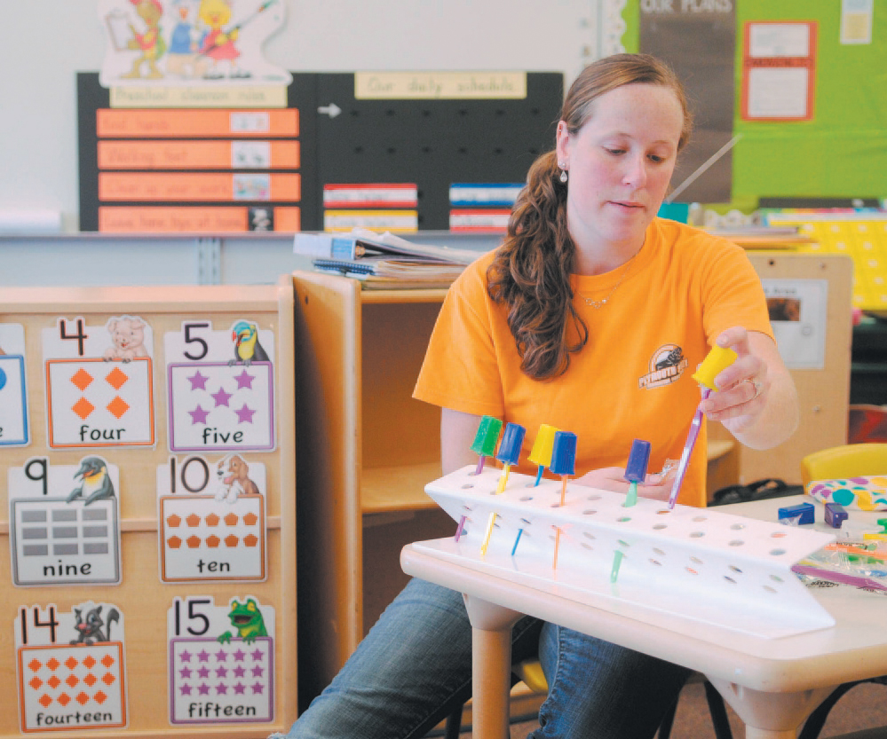 In this 2013 file photo, Windsor Elementary School pre-kindergarten teacher Brittany Hill gets ready at the start of a new school year. Voters in Windsor and Palermo will decide Tuesday whether to withdraw from Regional School Unit 12. 
