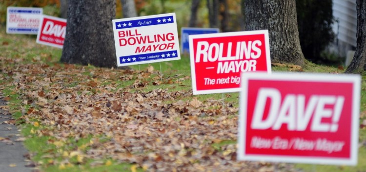 Signs for the two of the candidates for mayor are seen along Townsend Road on Friday in Augusta.