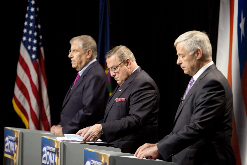 The three candidates for governor, from left independent Eliot Cutler, Republican Gov. Paul LePage and Democratic U.S. Rep. Mike Michaud, look over their notes as they prepare for Tuesday night’s debate at WMTW-TV’s studio in Auburn Gabe Souza/Staff Photographer