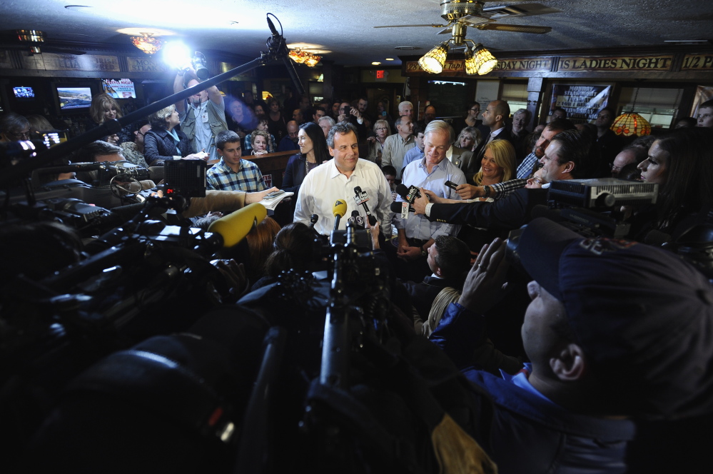 New Jersey Gov. Chris Christie answers questions from the media about nurse Kaci Hickox's quarantine as Republican candidate for Connecticut governor Tom Foley, right, listens, Monday, Oct. 27, 2014, in Groton, Conn. (AP Photo/Jessica Hill)