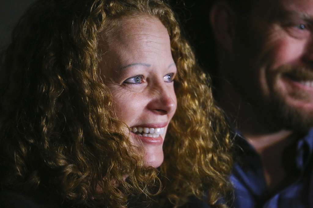 Kaci Hickox speaks to the press outside her boyfriend's home on Wednesday night. She said she has been told that Maine's attorney general intends to file legal action, and if that occurs, she will fight it.