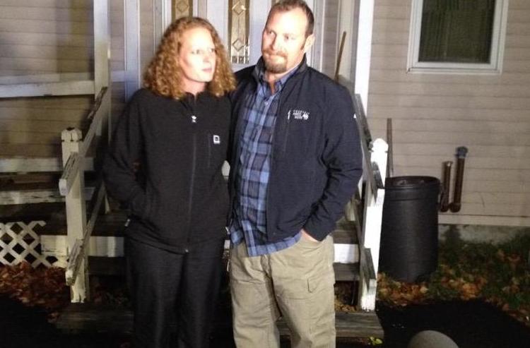 Nurse Kaci Hickox and Theodore Wilbur talk to the media outside Wilbur's house in Fort Kent on Wednesday night. Hickox described the experience as emotionally draining as she waits to see if the state is going to seek a court order to quarantine her. 