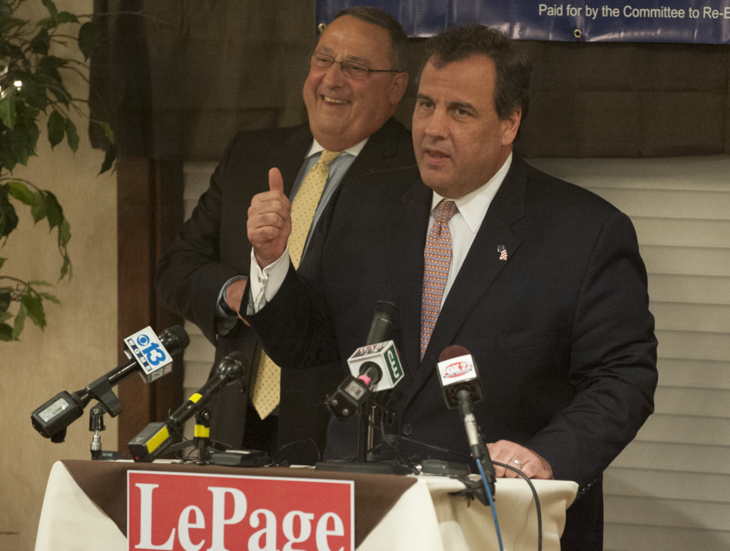 Maine Gov. Paul LePage listens as New Jersey Gov. Chris Christie gives a campaign speech for him during a rally at the Bangor Banquet and Conference Center on Tuesday. Christie told more than 200 supporters, "Paul LePage governs from the heart." 