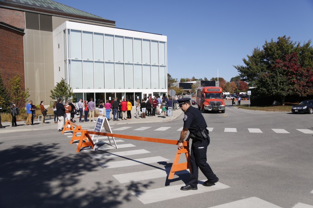 Police set up barricades as people wait in line outside the Collins Center for the Arts at the University of Maine in Orono to see First Lady Michelle Obama speak in support of Democratic candidate for governor, U.S. Rep. Mike Michaud, on Friday. 