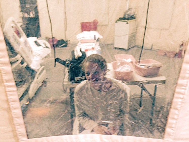 This Sunday photo provided by attorney Steven Hyman shows nurse Kaci Hickox in an isolation tent at University Hospital in Newark, N.J., where she was quarantined after flying into Newark Liberty International Airport following her work in West Africa caring for Ebola patients.