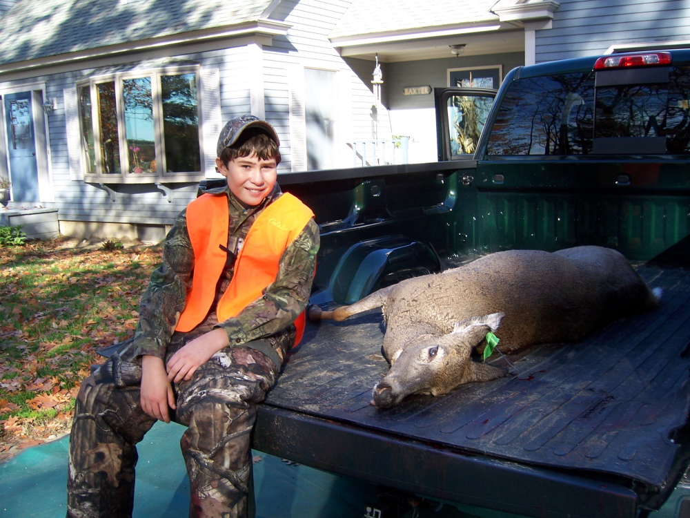 Cameron Couture, 11, of Wilton, shows off his first deer, a 138-pound doe he shot in Leeds last Saturday on Youth Hunting Day. Deer season for the rest of the state’s residents opens today.