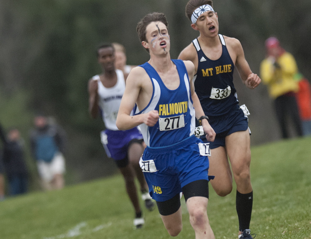 Falmouth runner Bryce Murdick, front, gets ahead of Mt. Blue’s Aaron Willingham for a bit in the final stretch of the Class A state championship race Saturday, but Willingham surged ahead late to win the race in Belfast.