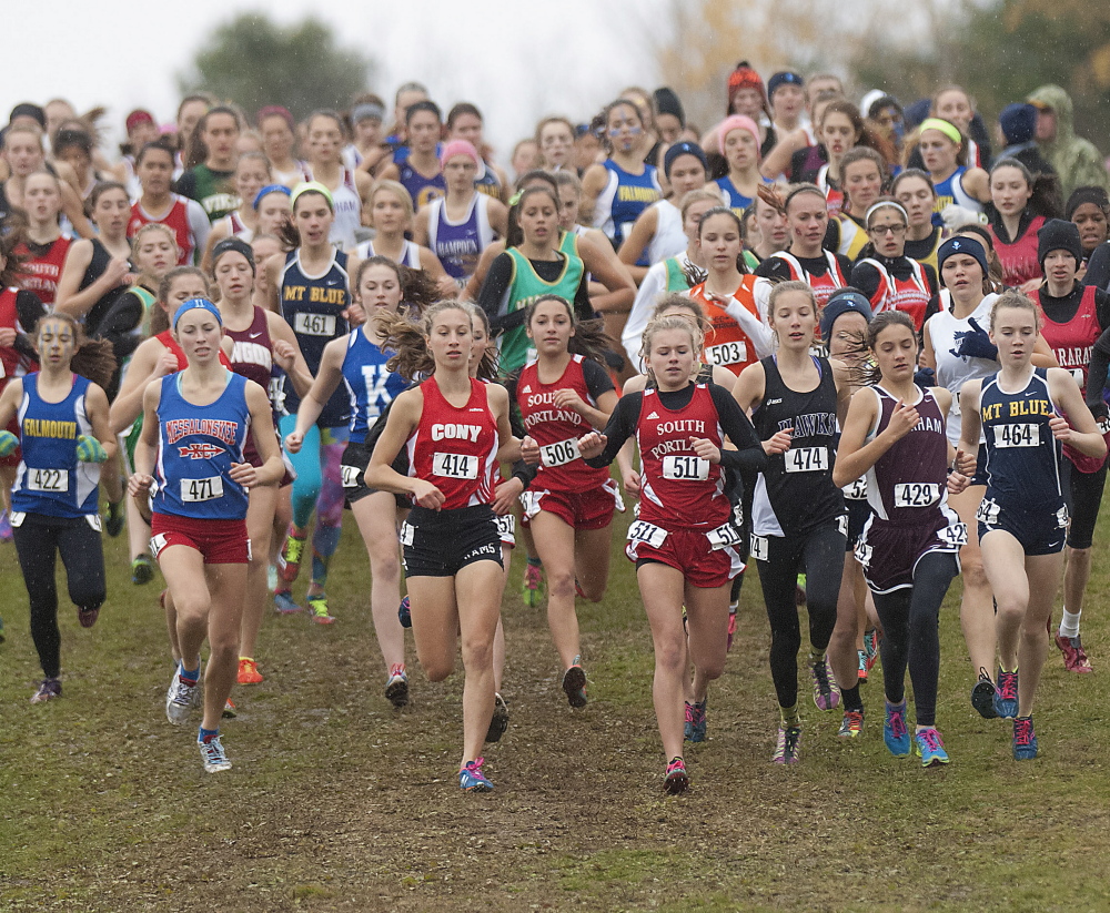Runners, including Cony’s Anne Guadelupi (414), begin to form a column at the start of the Class A state championship race in Belfast on Saturday.