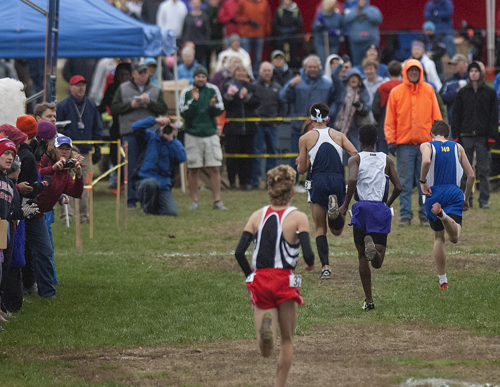 Mt. Blue’s Aaron Willingham crosses the line just ahead of Falmouth’s Bryce Murdick to win the Class A state championship Saturday in Belfast.