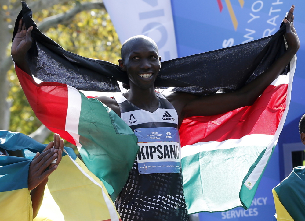 Wilson Kipsang of Kenya celebrates with his country’s flag after winning the 2014 New York City Marathon in Central Park in Manhattan on Sunday.