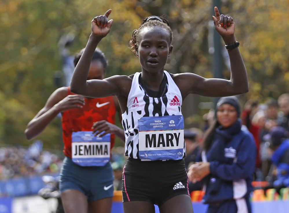 Mary Keitany celebrates as she edges out Jemima Sumgong, both of Kenya, after the pair finished first and second in the women’s division of the 44th annual New York City Marathon in New York on Sunday.