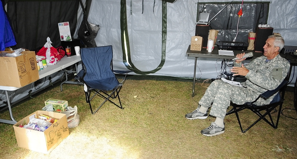 In this 2013 file photo, B-98.5 radio personality Randy McCoy broadcasts from an Army tent near the tank at the Camp Keyes gate on Airport Road. This year, the annual Tanksgiving food drive runs Monday through Nov. 7.