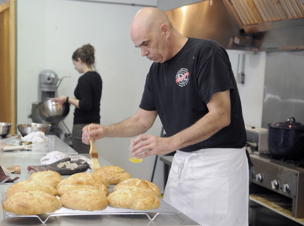 Thomas “TJ” Quinn and Jessi Donahue bake in the kitchen at Apple Valley Bakery in Monmouth. Quinn and Kelly Sanborn Webb recently opened the bakery on Main Street.